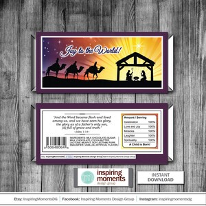 May include: A printable Christmas card with a purple background and a scene of the three wise men on camels approaching a stable with a star in the sky. The text "Joy to the World!" is at the top of the card. The card also includes a scripture verse from John 1:14 and a list of ingredients for the chocolate used in the card. The card is designed to be used as a gift tag or a small card.