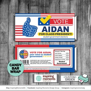 May include: Candy bar wrapper with a red, white and blue American flag design. The wrapper features a thumbs up hand gesture with the text "Vote Aidan for Class President!" and "Vote for Aidan, your voice in student government!" The wrapper also includes a nutrition facts label with the text "Student Government!"