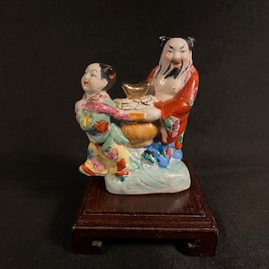 Chinese Porcelain Figurine Man and Boy with Bag of Gold
