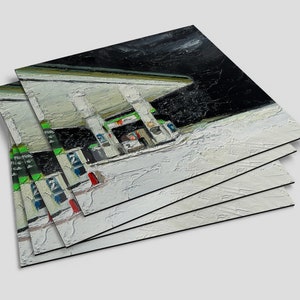May include: A stack of five white canvases with a painting of a petrol station at night. The painting is done in a realistic style with a focus on the details of the petrol station.