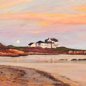 Gooseberry Beach in Newport Rhode Island at sunset with a moonrise. View of the white house on the point with reflections of sunset on the water.