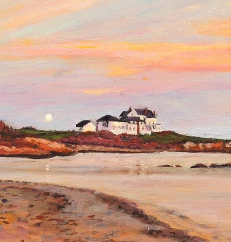 Gooseberry Beach in Newport Rhode Island at sunset with a moonrise. View of the white house on the point with reflections of sunset on the water.