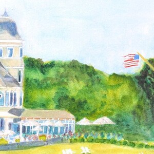 Detail view of the right side of the Castle Hill Inn in Newport Rhode Island and flag pole as seen from the west lawn featuring the turret and restaurants with umbrellas.