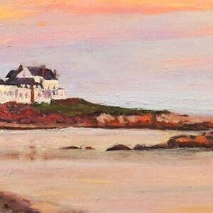 Gooseberry Beach in Newport Rhode Island at sunset with a moonrise. View of the white house on the point with reflections of sunset on the water.