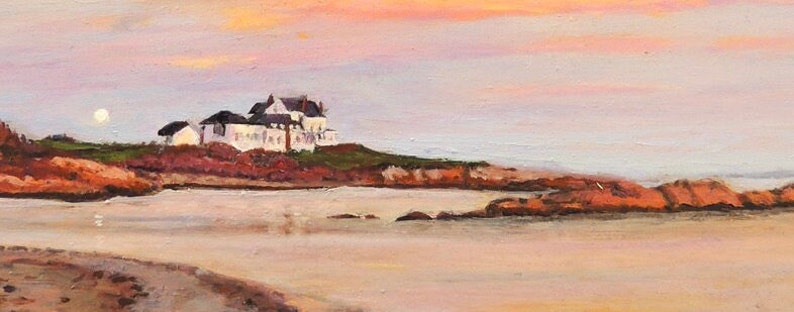 Gooseberry Beach in Newport Rhode Island at sunset with a moonrise. View of the white house on the point with reflections of sunset on the water.