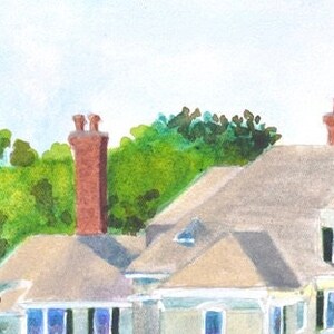 detail view of the top left roof gables and chimneys of the Castle Hill Inn in Newport Rhode Island against a backdrop of green trees.