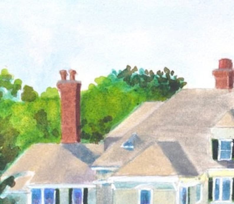 detail view of the top left roof gables and chimneys of the Castle Hill Inn in Newport Rhode Island against a backdrop of green trees.