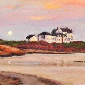 Gooseberry Beach in Newport Rhode Island at sunset with a moonrise. View of the white house on the point with reflections of sunset on the water.