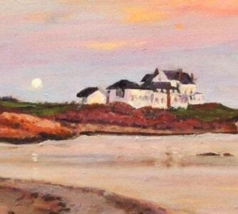 Gooseberry Beach in Newport Rhode Island at sunset with a moonrise. View of the white house on the point with reflections of sunset on the water.