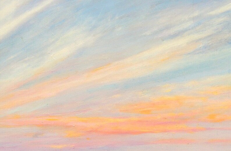 Detail closeup of the sunset sky over Gooseberry beach with whisps of blue, white, orange, peach, red, lavender