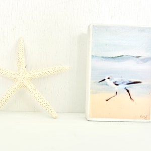 Little Sanderling Running Along the Shoreline print mounted on freestanding white wood block