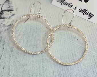 Drop hoop earrings, sterling silver, sparkly.