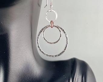 Sterling Silver circle earrings with copper accent.