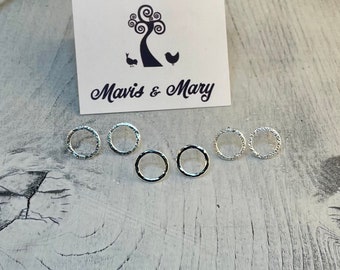 Open circle stud earrings in sterling silver.