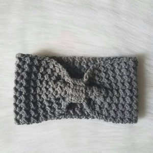 May include: A gray crocheted headband with a bow in the center.
