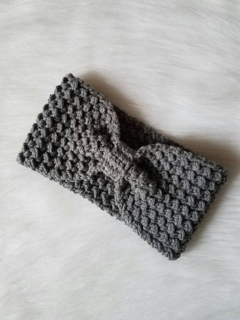 May include: Gray knitted headband with a knotted bow detail.