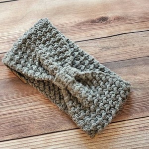 May include: Gray crocheted headband with a knotted bow detail.