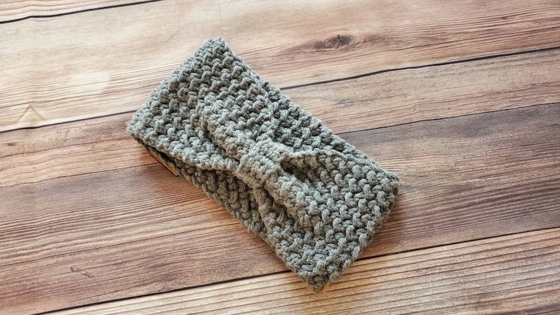 May include: Gray crocheted headband with a knotted bow detail.