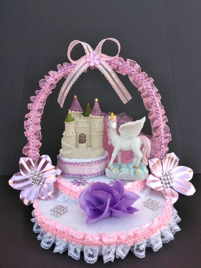 Beautiful original baby girl unicorn birthday cake topper party celebration pink table centerpiece decoration.