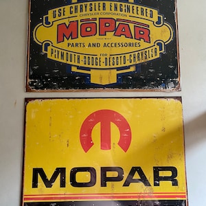 May include: Two vintage-style metal signs advertising Mopar parts and accessories. The top sign is black with yellow lettering and the bottom sign is yellow with black lettering. Both signs feature the Mopar logo.