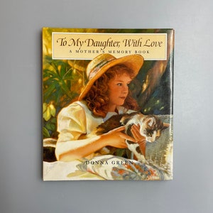May include: A book cover titled "To My Daughter, With Love" showing a painting of a young woman in a straw hat holding a calico cat. The book is a mother's memory book, by Donna Green.