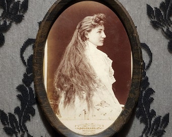 Antique framed cabinet photo of a Victorian woman with long hair. A rare find!