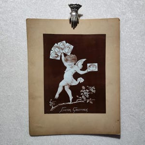 Grande photo antique de voeux de Pâques de l'époque victorienne. Très rare chérubin tenant une armoire à photos.