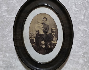 Antique late Victorian era or Early Edwardian era photo of a ghostly family housed in original tin, oval frame. Identified.