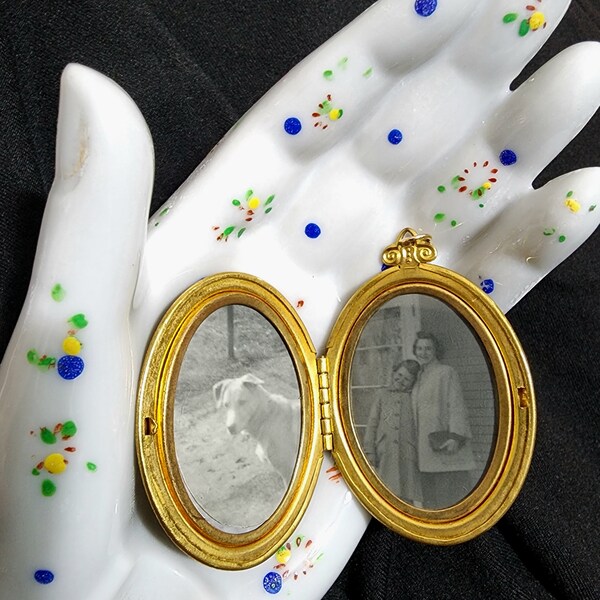 Antique locket. Engraved with filigree and floral designs. Two original photos inside. Kids and a dog! 1930s