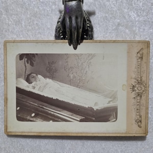 A Haunting cabinet card post mortem. ghostly antique picture of a young girl in her coffin. Identified as Leena.