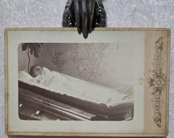 A Haunting cabinet card post mortem. ghostly antique picture of a young girl in her coffin. Identified as Leena.