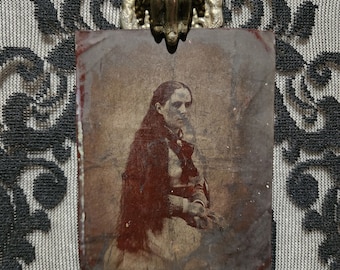 Victorian era tintype photo of a beautiful woman with long locks of hair.