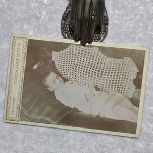 A Haunting cabinet card post mortem. ghostly antique picture of a deceased young child.