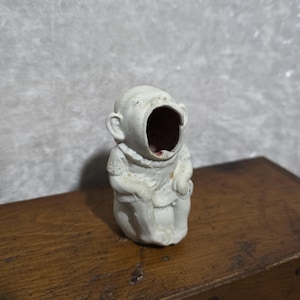 Antique occupied Japan knick knack of a little wide mouth child seated on a pot. Dollhouse. Toothpick holder. Bisque