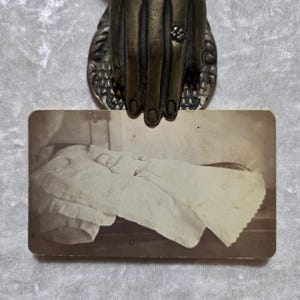Antique, CDV photo of a haunting post mortem baby in a burial gown. Victorian mourning era.