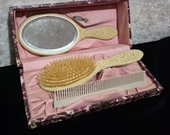Antique travel vanity set, likely from the Victorian or Edwardian era, featuring celluloid or "French Ivory" components with floral carving.