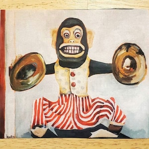 May include: A vintage toy monkey with a black face and red and white striped pants plays cymbals. The monkey has a mischievous grin and is painted in a cartoon style.