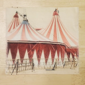 May include: A vintage-style illustration of two red and white striped circus tents with a brown fence in front of them.