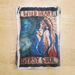 May include: A vintage-style fabric patch with a colorful illustration of a woman wearing a headdress. The text "WILD HEART GYPSY SOUL" is printed in bold letters on the patch.