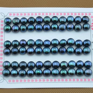 May include: A close-up of three rows of dark green pearls. The pearls are round and smooth, and they are arranged in a neat pattern.