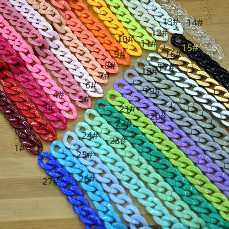 May include: A variety of colorful plastic chain links, numbered 1 through 27, arranged in a row. The chains are different colors, including red, pink, orange, yellow, green, blue, purple, and white.