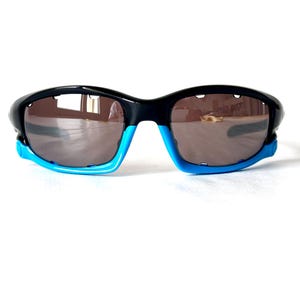 May include: Black and blue wraparound sunglasses with dark lenses.