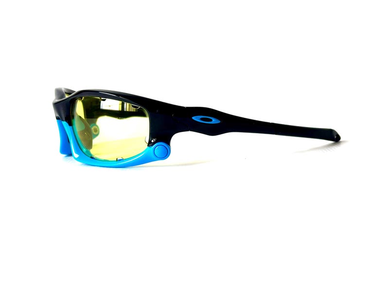 May include: Black and blue sunglasses with yellow lenses. The sunglasses have a sporty design and are made of durable plastic.