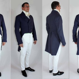 May include: A man wearing a dark blue tailcoat with white pants and a white cravat. The tailcoat has a long, pointed tail and is double-breasted. The man is standing in front of a white background.