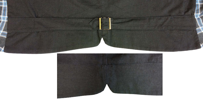 May include: The back of a black vest with a gold buckle. The vest has a seam down the center back and two pockets on the bottom.