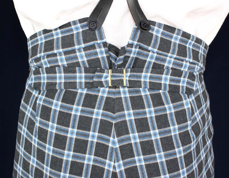 May include: Black and white plaid pants with a blue and white check pattern. The pants have suspenders and a belt.