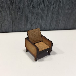 May include: A miniature wooden armchair with a brown finish. The chair has a simple design with a curved back and armrests.