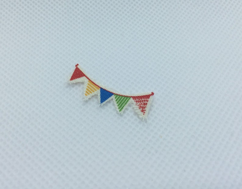 May include: A colorful string of bunting with red, yellow, green, and blue triangular flags.