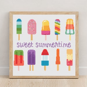 May include: A cross-stitch pattern featuring a variety of colorful popsicles with the text "Sweet Summertime".