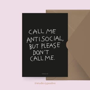 May include: A black rectangular greeting card with white hand-drawn style text that reads: CALL ME ANTISOCIAL, BUT PLEASE DON'T CALL ME. The card is positioned next to a brown envelope. The small text at the bottom of the card reads: TYPEALIVE.